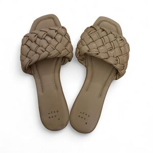 Tan leather flat sandals with braided design. A new day. Size 7.